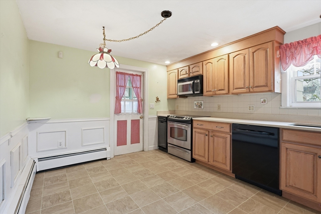 53 Kendall Street Lawrence, MA 01841 - Photo 5 of 36 a kitchen with granite countertop a stove sink and cabinets