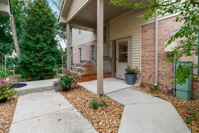 a view of a house with potted plants