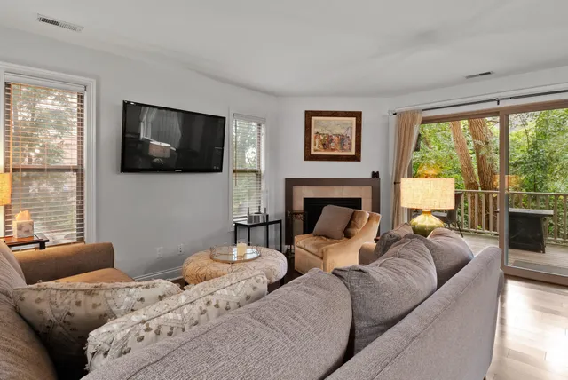 a living room with furniture a large window and a flat screen tv