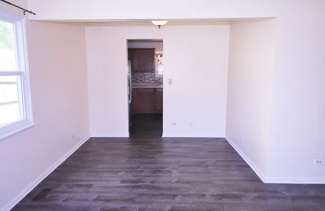 a view of hallway with wooden floor