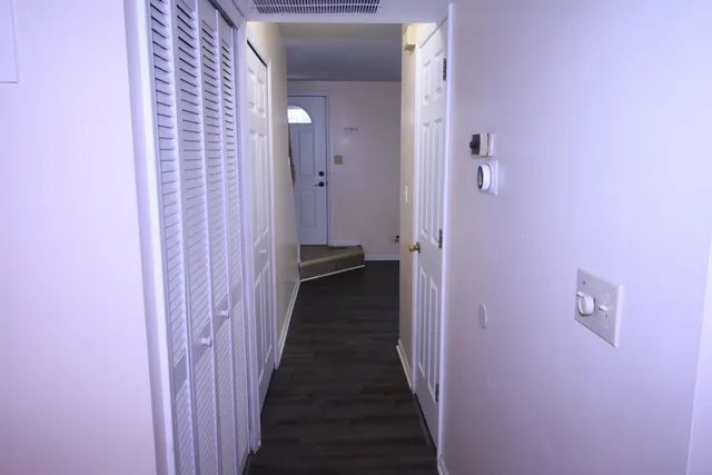 a view of a hallway with a wooden door
