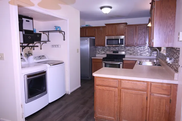 a kitchen with a sink stove and refrigerator