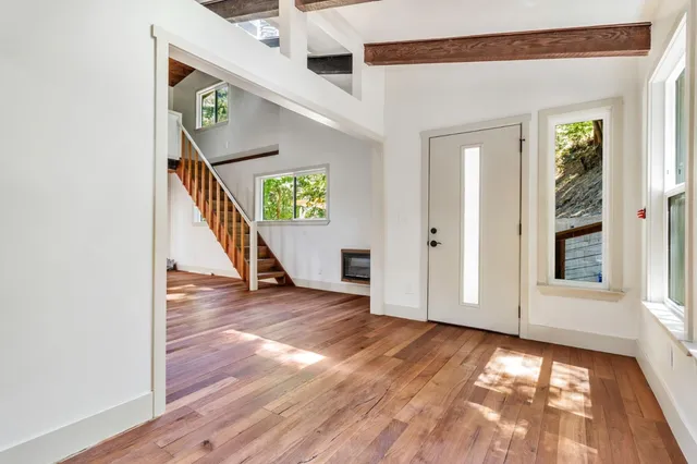 a kitchen with stainless steel appliances granite countertop a refrigerator a sink and a stove