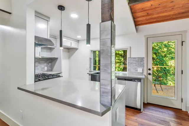 a kitchen with stainless steel appliances granite countertop a sink stove and refrigerator