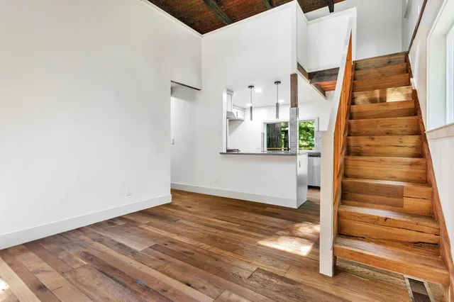a view of empty room with wooden floor