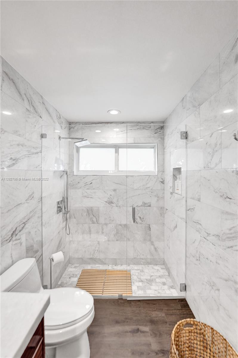 10150 Camelback Lane Boca Raton, FL 33498 - Photo 31 of 67 a bathroom with a granite countertop bathtub shower sink mirror and toilet