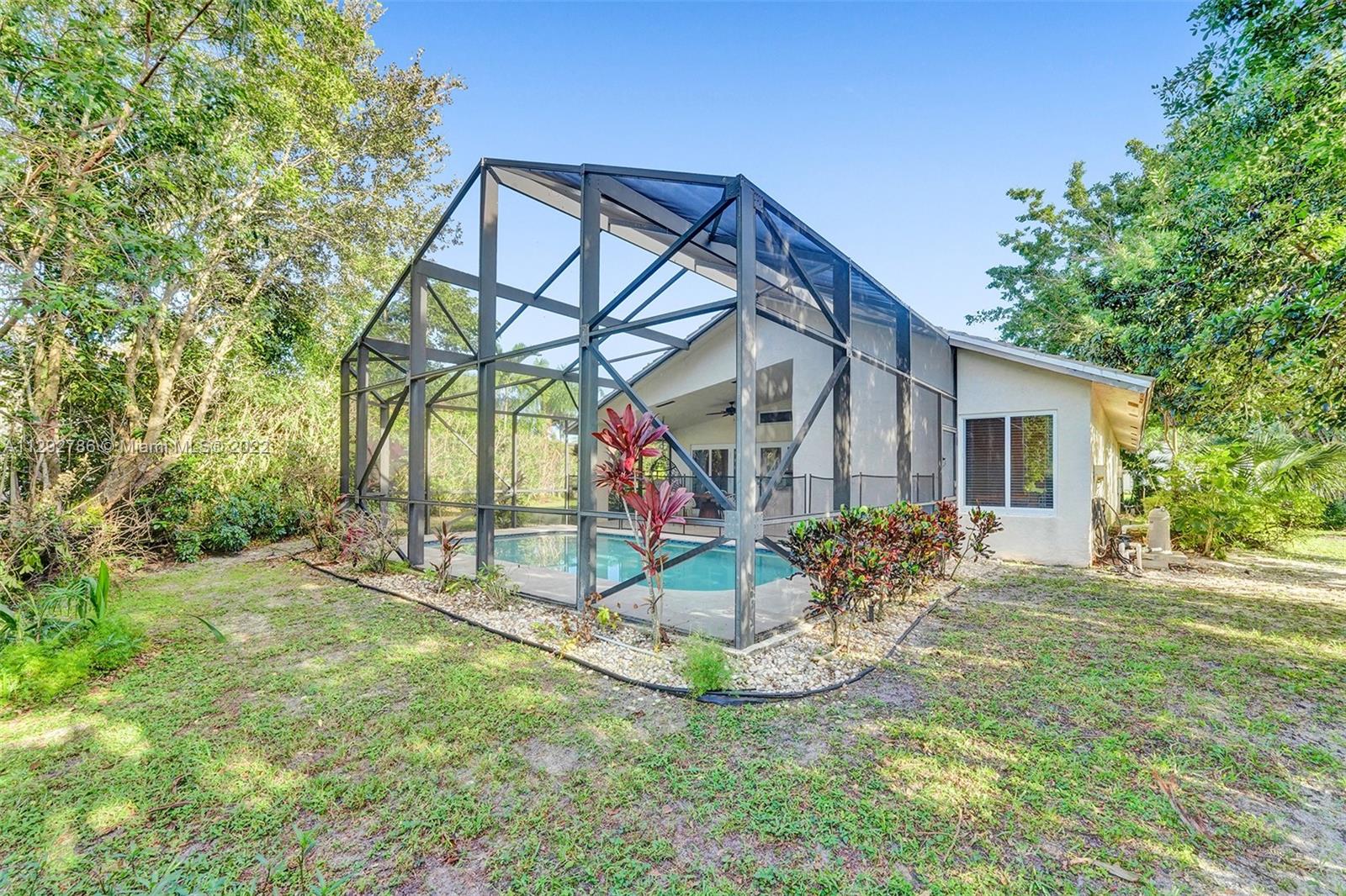 10150 Camelback Lane Boca Raton, FL 33498 - Photo 48 of 67 a view of two house with a yard and sitting area