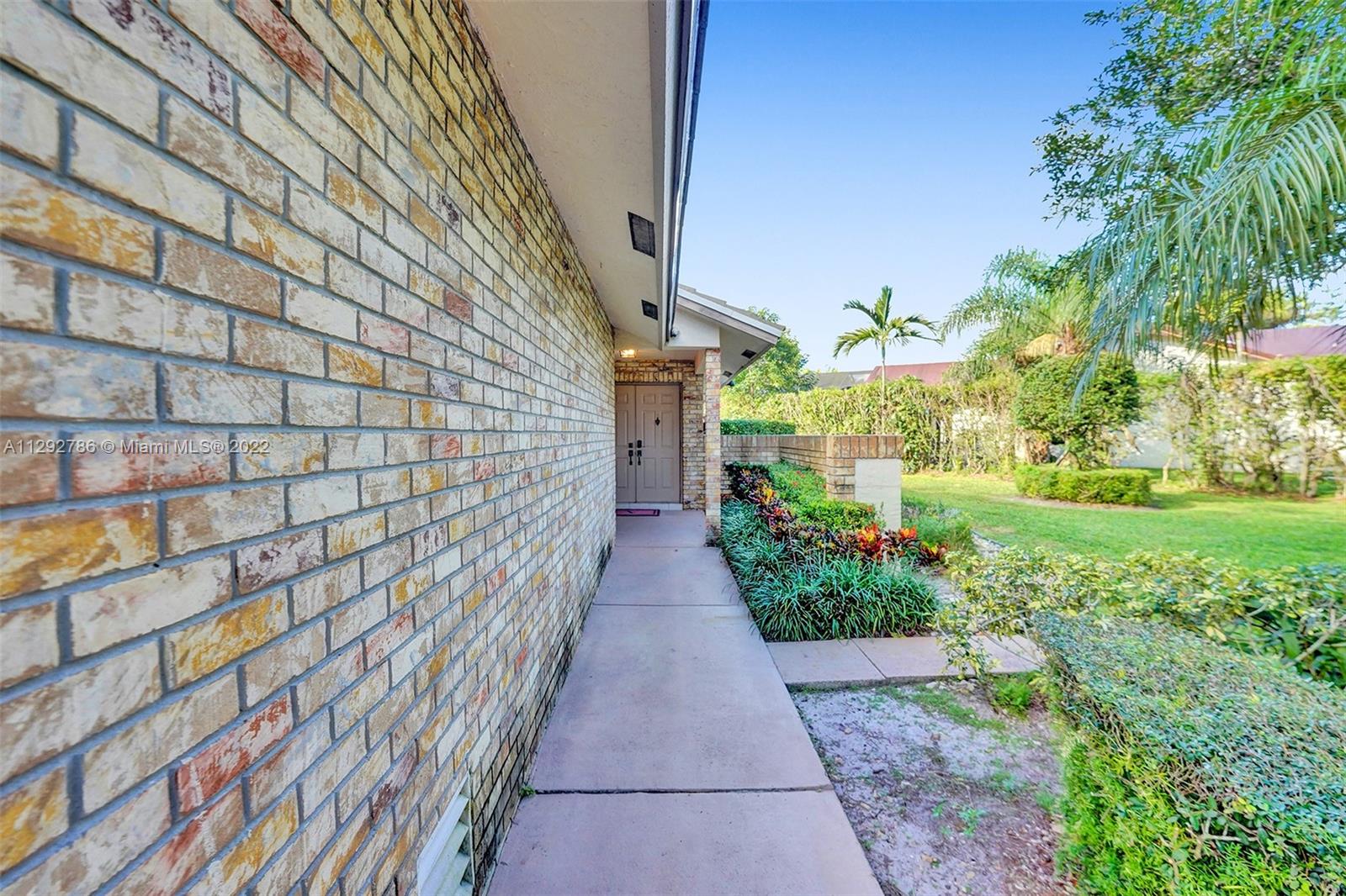 10150 Camelback Lane Boca Raton, FL 33498 - Photo 7 of 67 a view of a pathway with a yard