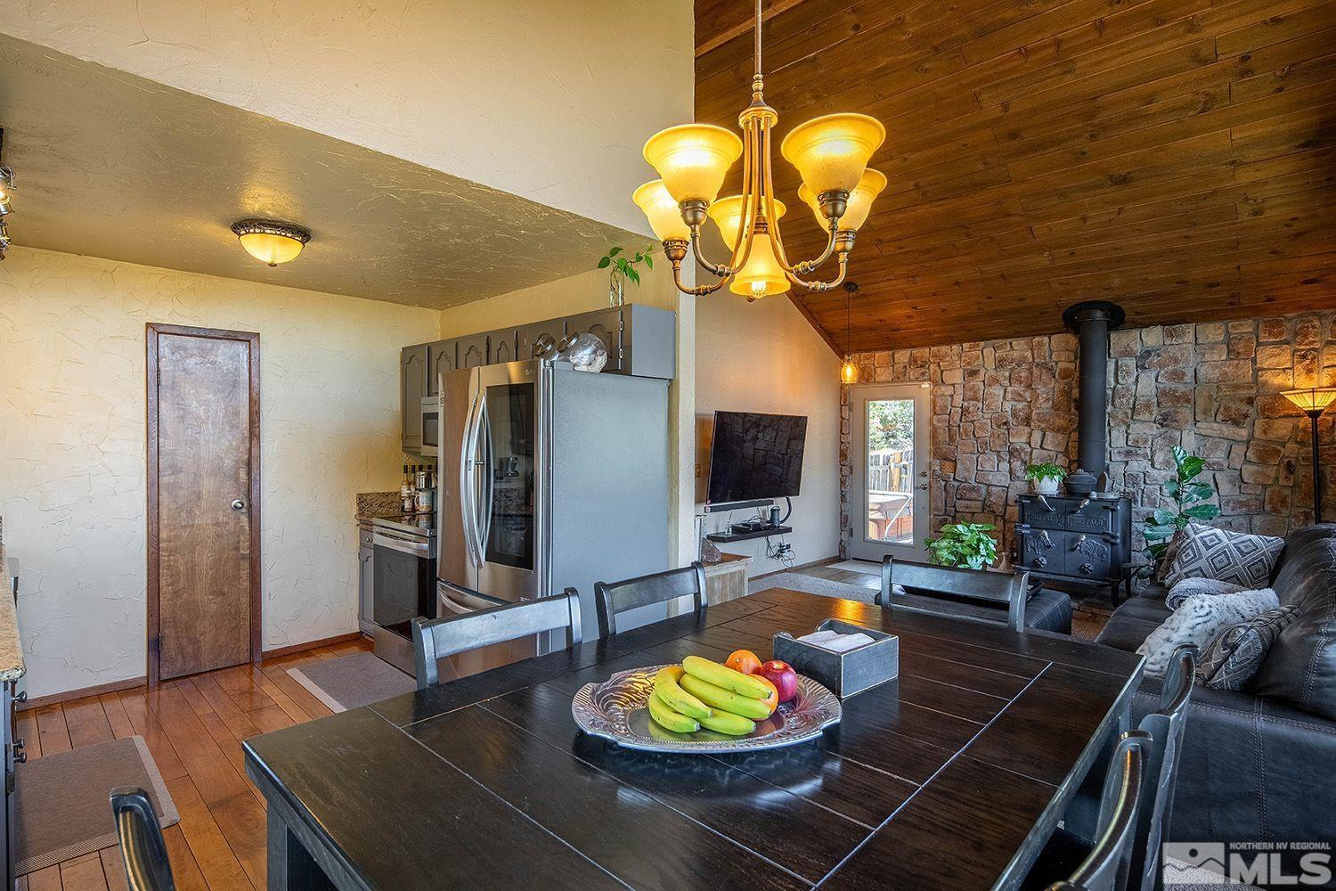 2090 Lousetown Road Reno, NV 89521 - Photo 11 of 30 a living room with furniture a flat screen tv and a chandelier
