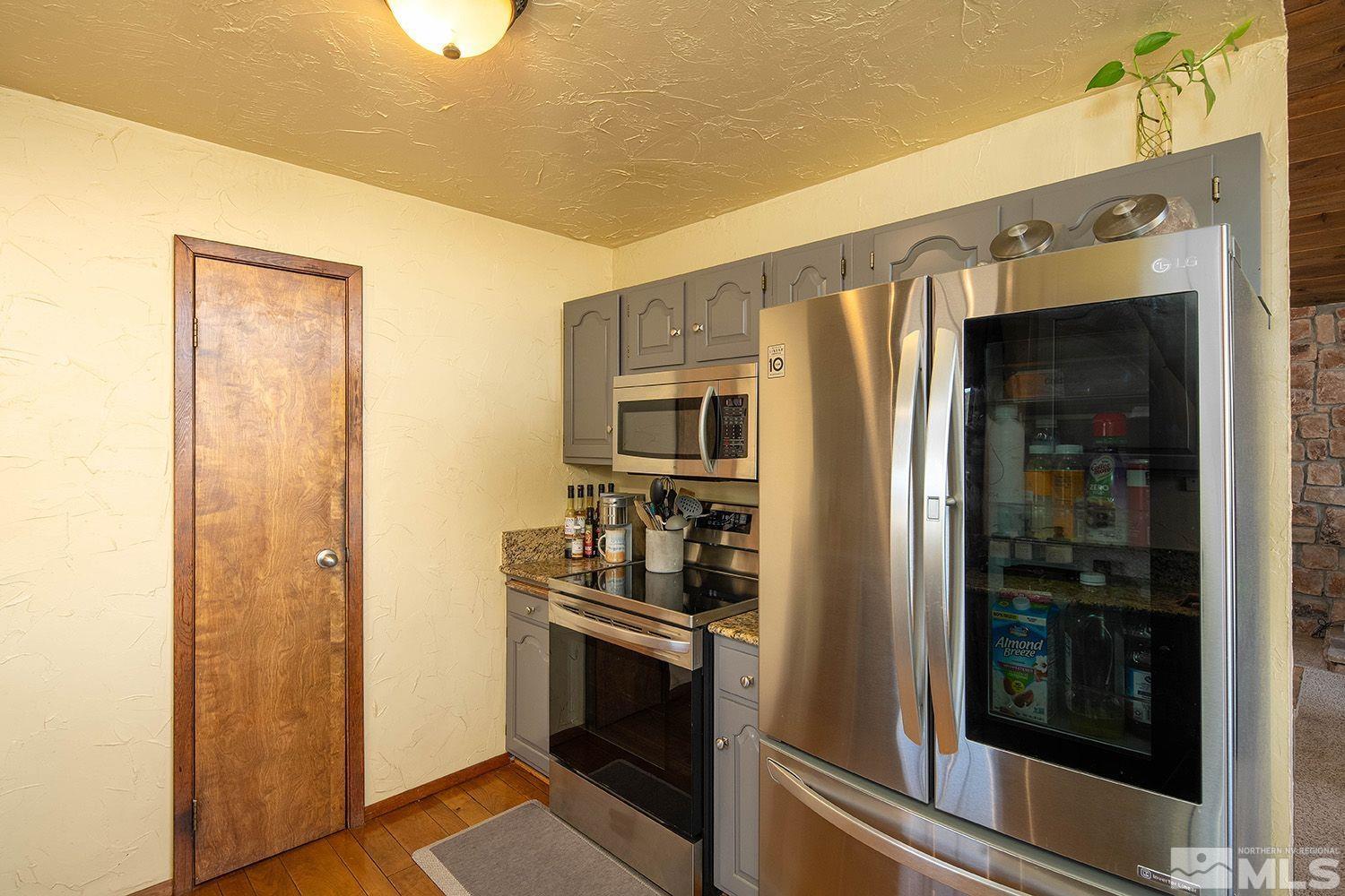 2090 Lousetown Road Reno, NV 89521 - Photo 13 of 30 a kitchen with stainless steel appliances a refrigerator and cabinets
