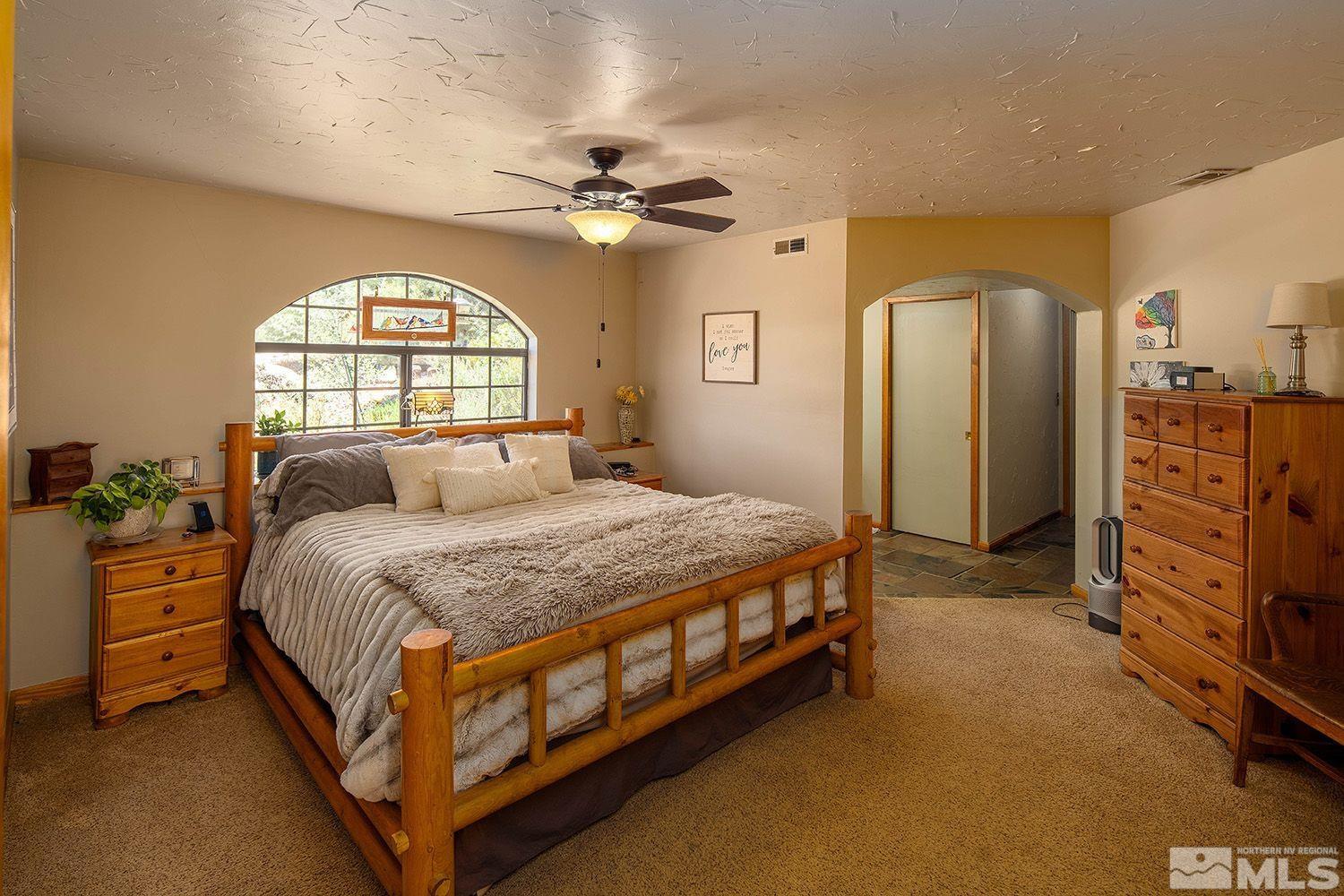 2090 Lousetown Road Reno, NV 89521 - Photo 14 of 30 a spacious bedroom with a bed and a large window