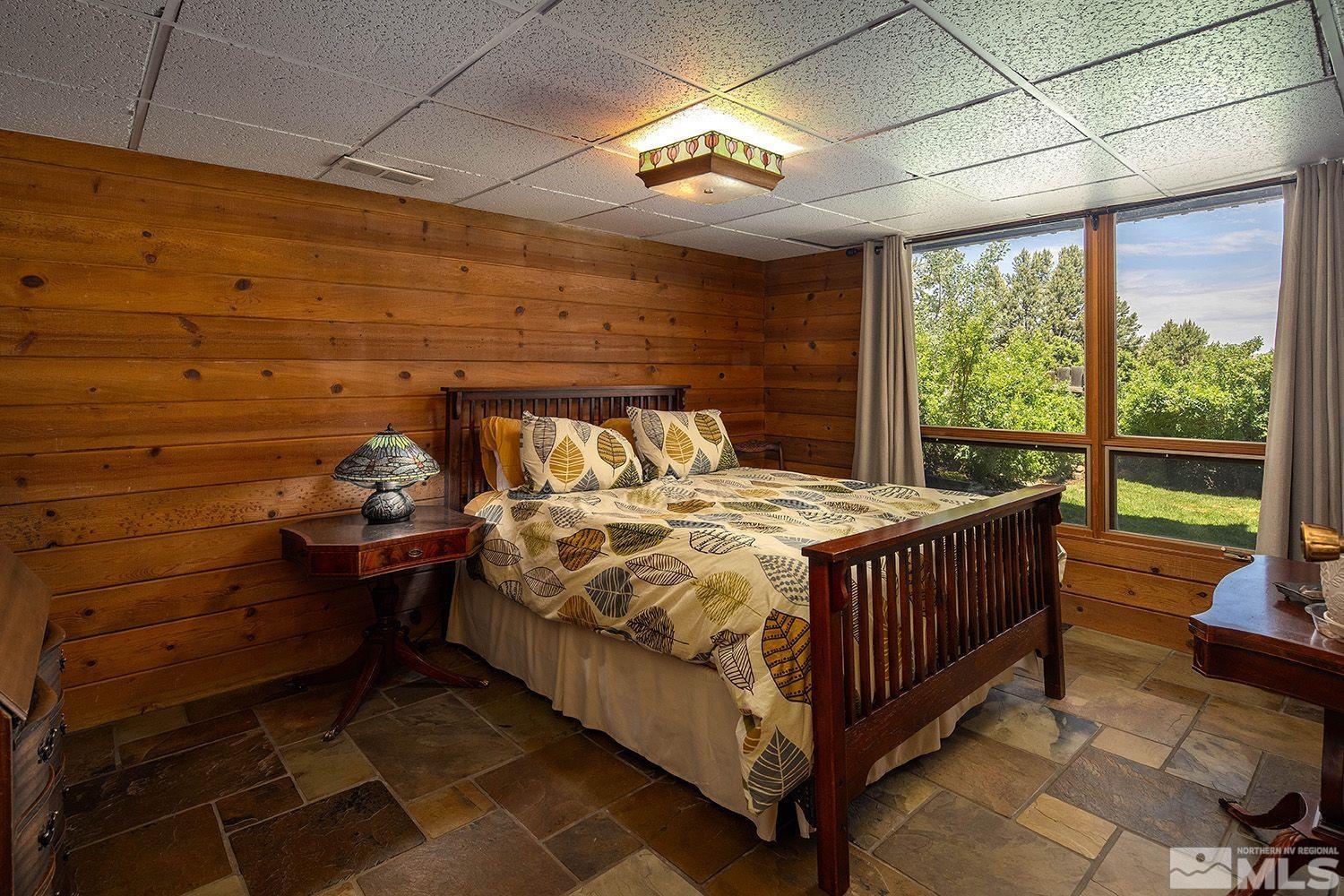 2090 Lousetown Road Reno, NV 89521 - Photo 16 of 30 a bed sitting in a bedroom next to a window