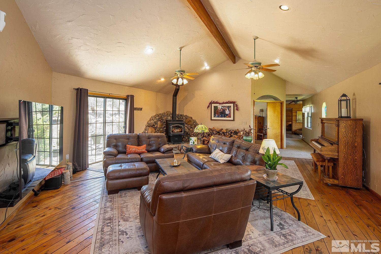 2090 Lousetown Road Reno, NV 89521 - Photo 6 of 30 a living room with fireplace furniture and a wooden floor