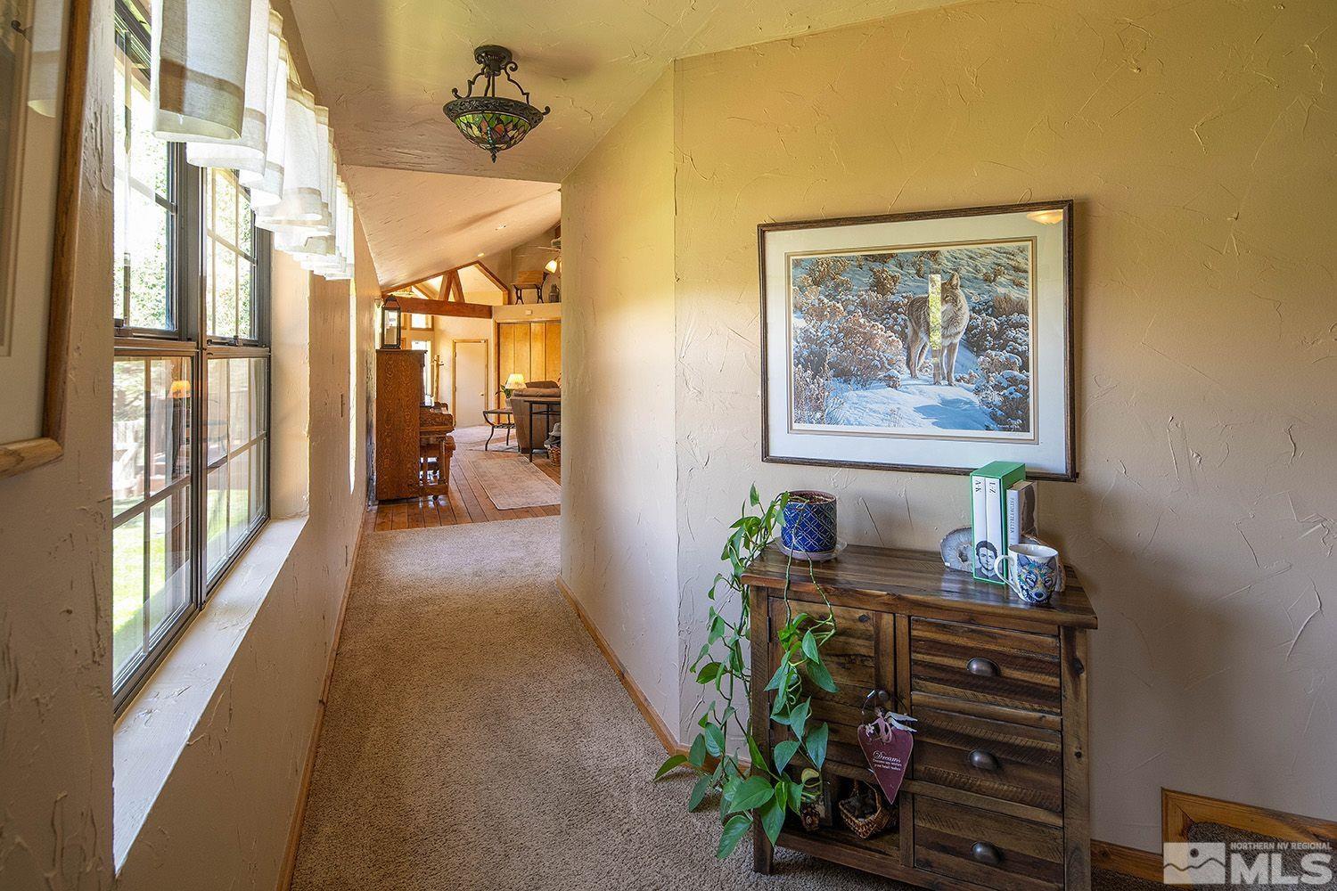 2090 Lousetown Road Reno, NV 89521 - Photo 7 of 30 a hallway with a table and a chandelier