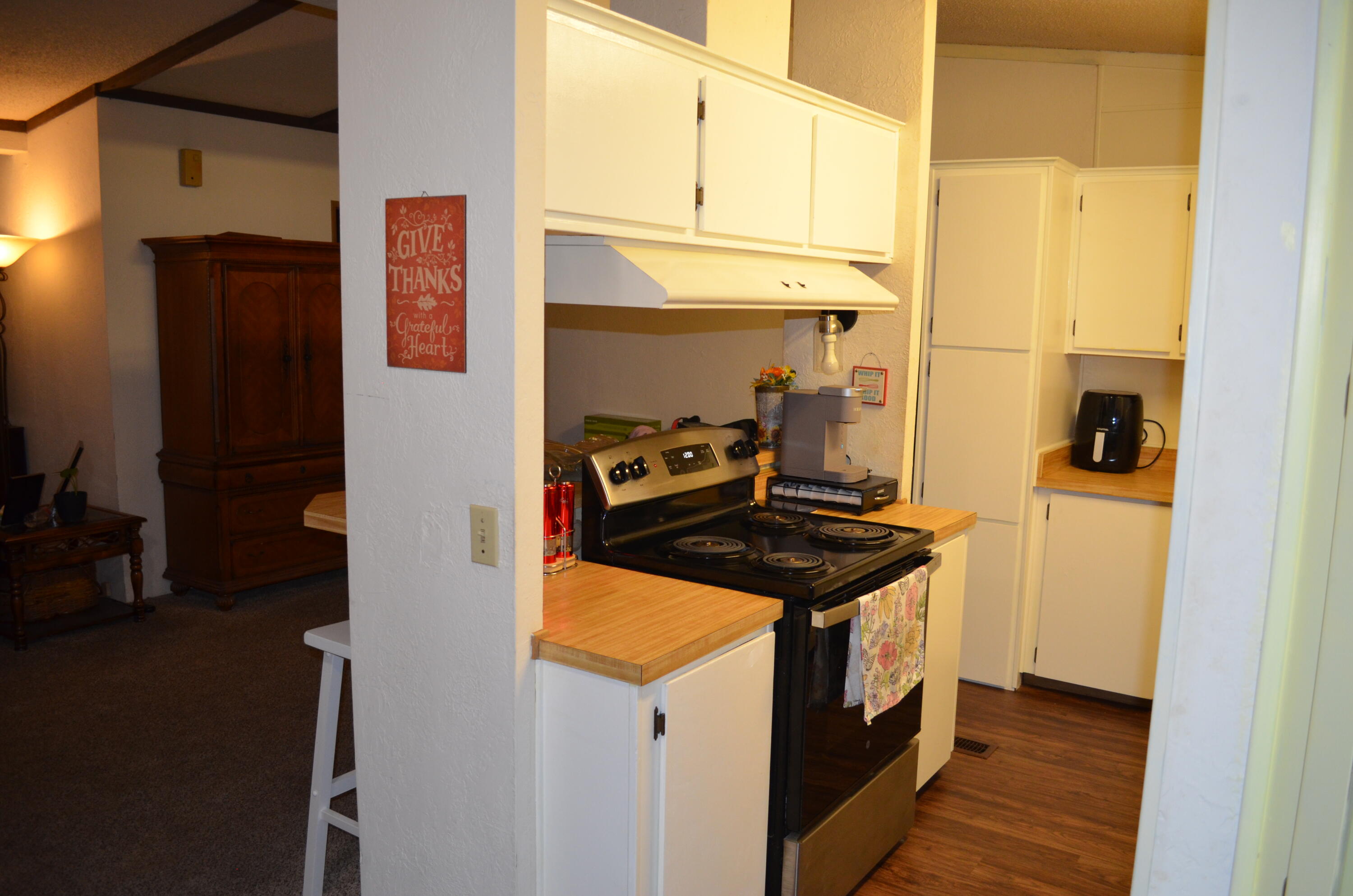 3835 Gardiner Ferry Road, Unit 17 Corning, CA 96021 - Photo 13 of 39 a kitchen with a stove and a refrigerator