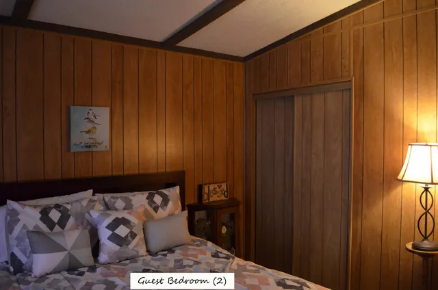 a bed sitting in a bedroom next to a wooden door