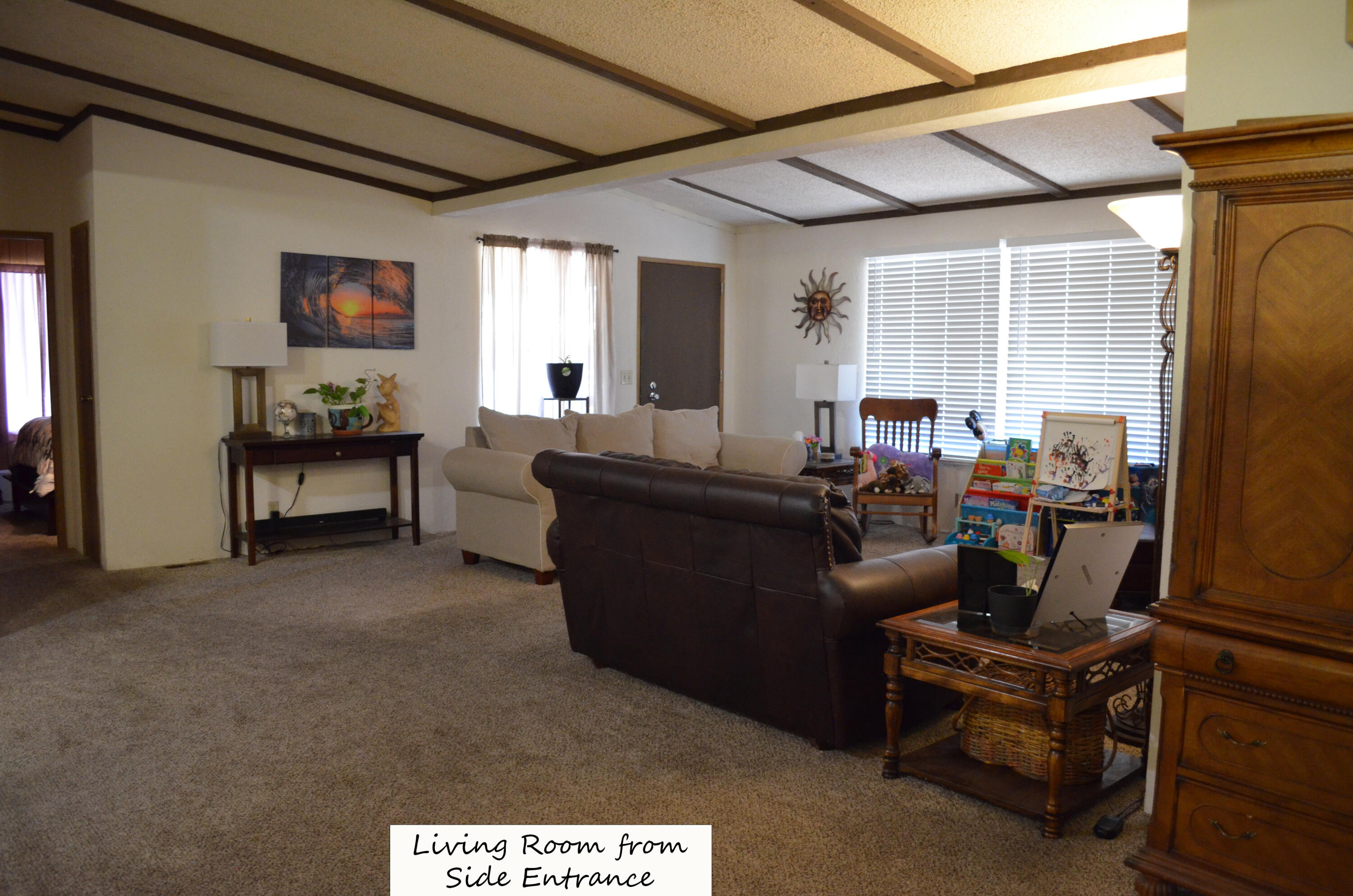 3835 Gardiner Ferry Road, Unit 17 Corning, CA 96021 - Photo 10 of 39 a living room with furniture and a large window