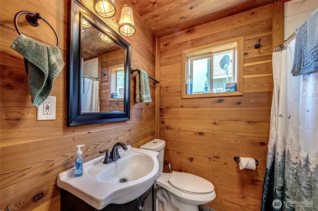 a bathroom with a sink a toilet and a mirror