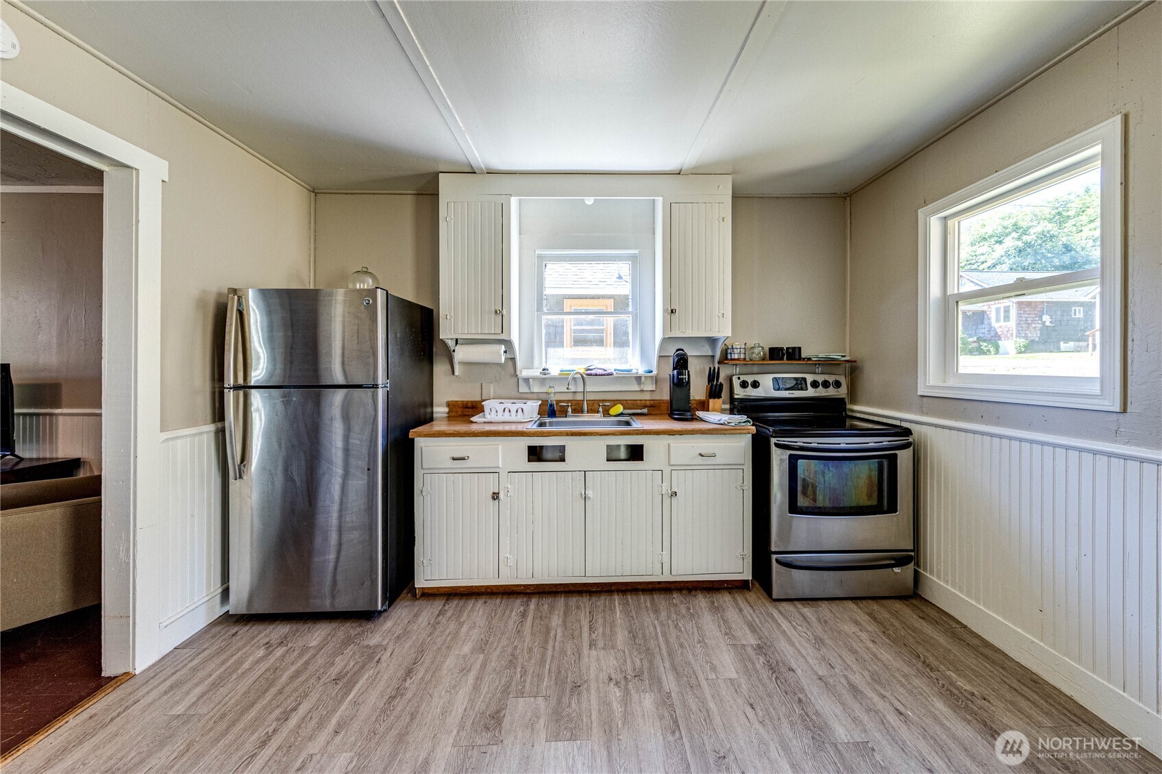 20 Smithville Road Beaver, WA 98305 - Photo 30 of 40 a kitchen with a refrigerator and a stove top oven