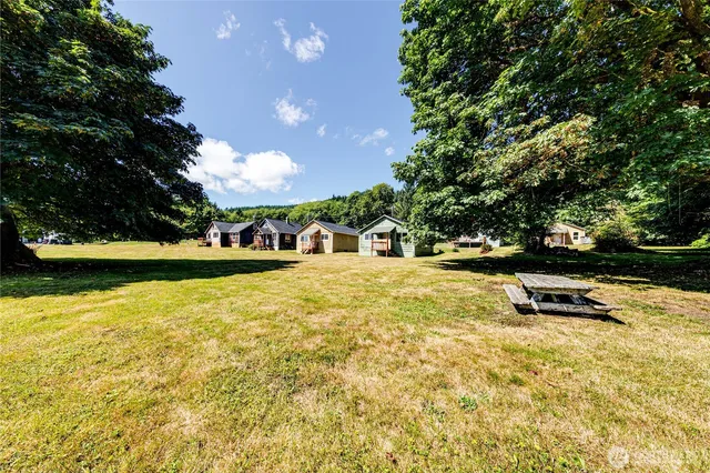 a view of a swimming pool with an outdoor seating and a yard