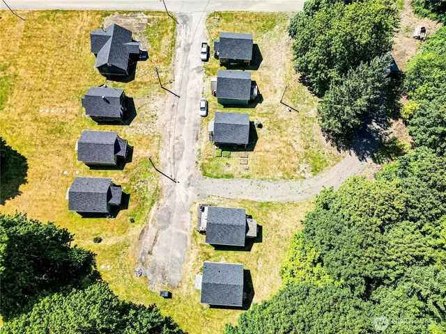 an aerial view of residential houses with parking space