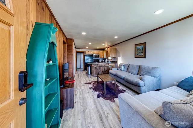 a living room with furniture and a wooden floor