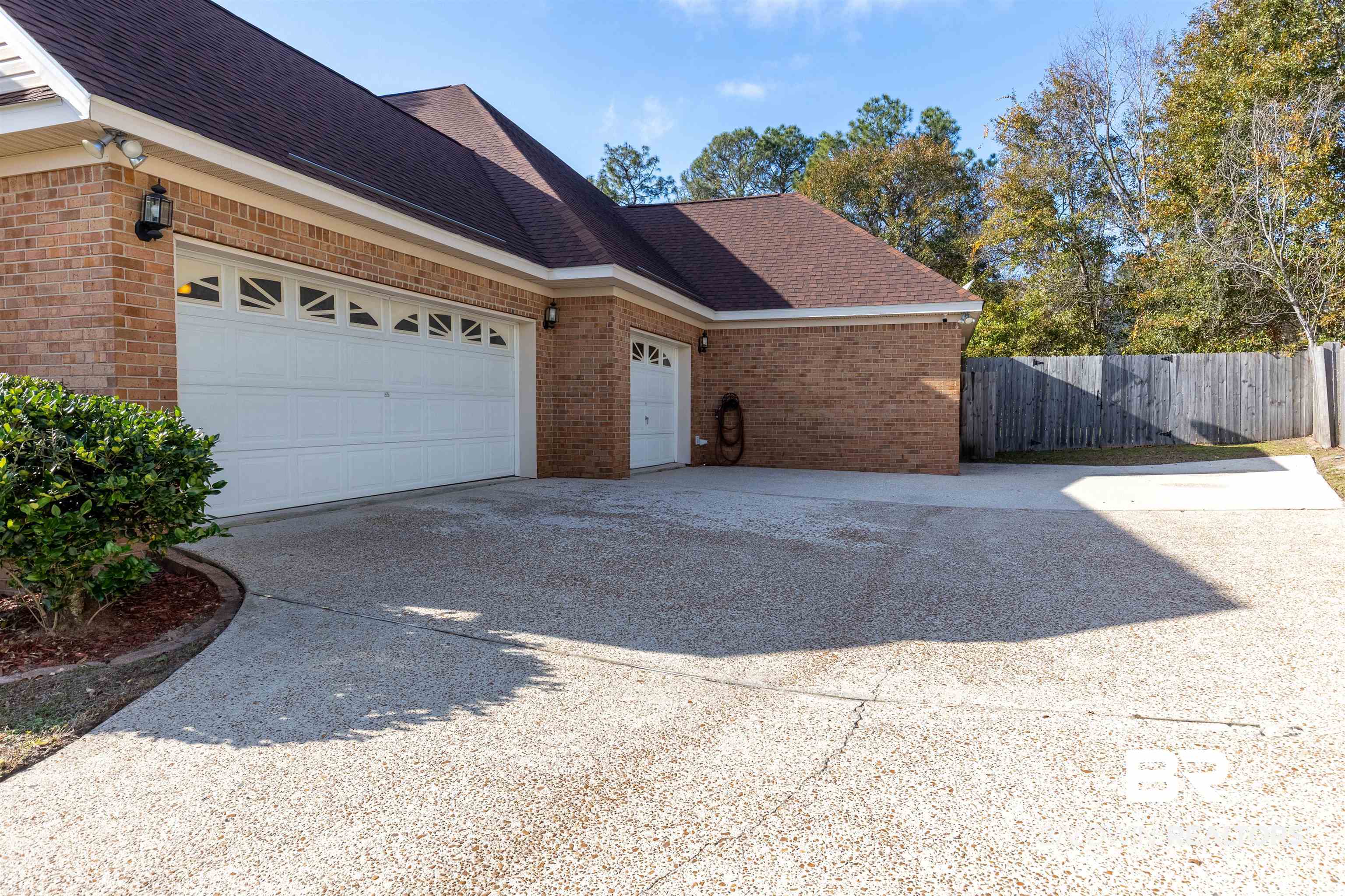 6436 Cherry Ridge Court West Mobile, AL 36695 - Photo 3 of 26 View of home's exterior featuring fence, driveway, an attached garage, and brick siding