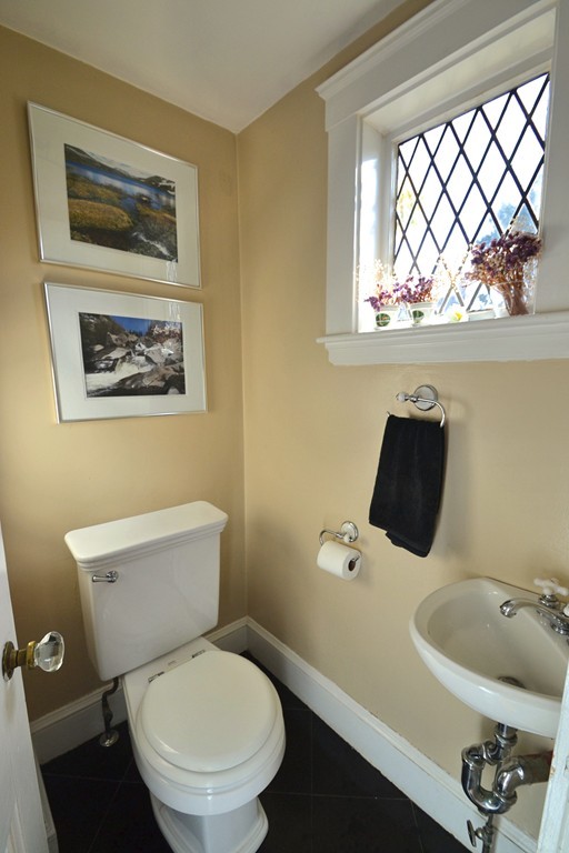 53 Arapahoe Road Newton, MA 02465 - Photo 15 of 25 a white toilet sitting next to a bathroom sink and a window