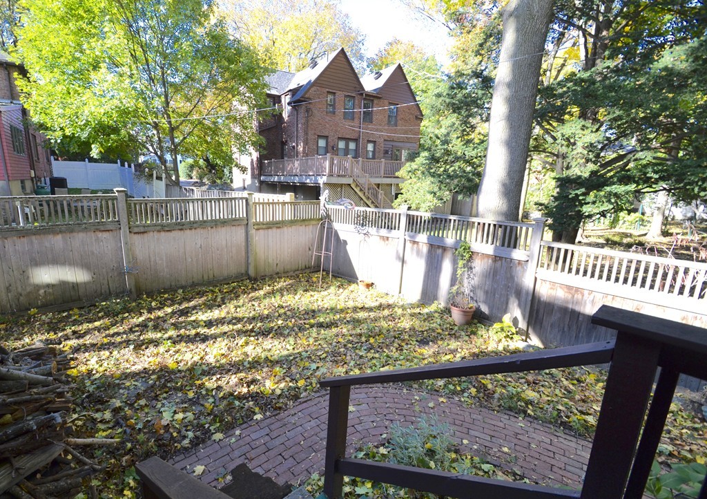 53 Arapahoe Road Newton, MA 02465 - Photo 24 of 25 a view of a wooden house with a small yard and wooden fence