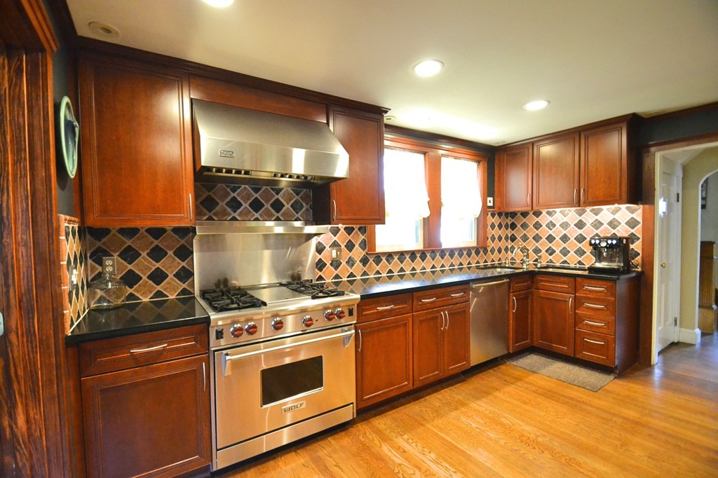 53 Arapahoe Road Newton, MA 02465 - Photo 3 of 25 a kitchen with stainless steel appliances granite countertop a stove a sink and a microwave