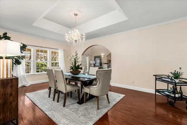 a living room with furniture a clock and a flat screen tv