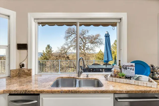 a living room with large window and furniture