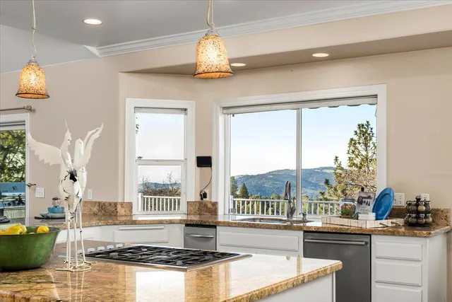 a kitchen with cabinets and wooden floor