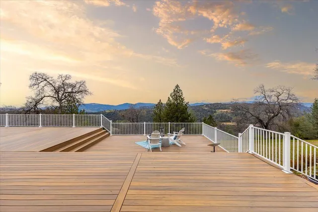 a front view of a house with a yard and tree s