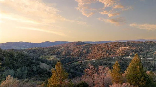 a view of a balcony with chairs and wooden fence