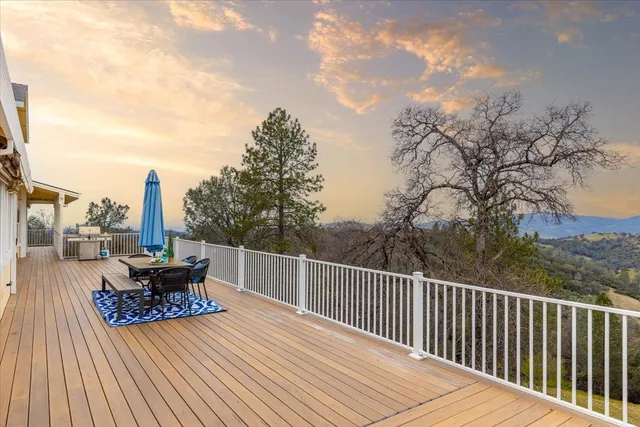 a spacious bedroom with a bed and a chandelier