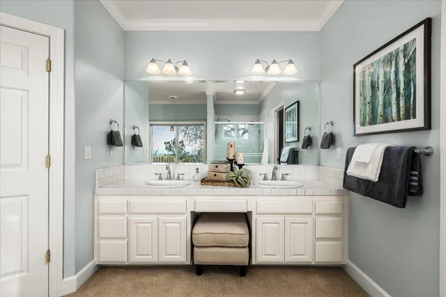 an empty room with chandelier fan and windows