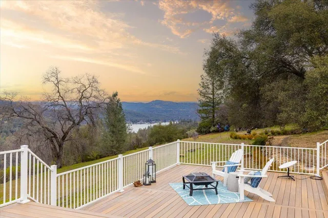 a living room with fireplace furniture and a large window