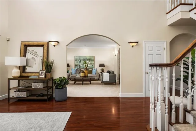 a living room with furniture and a chandelier