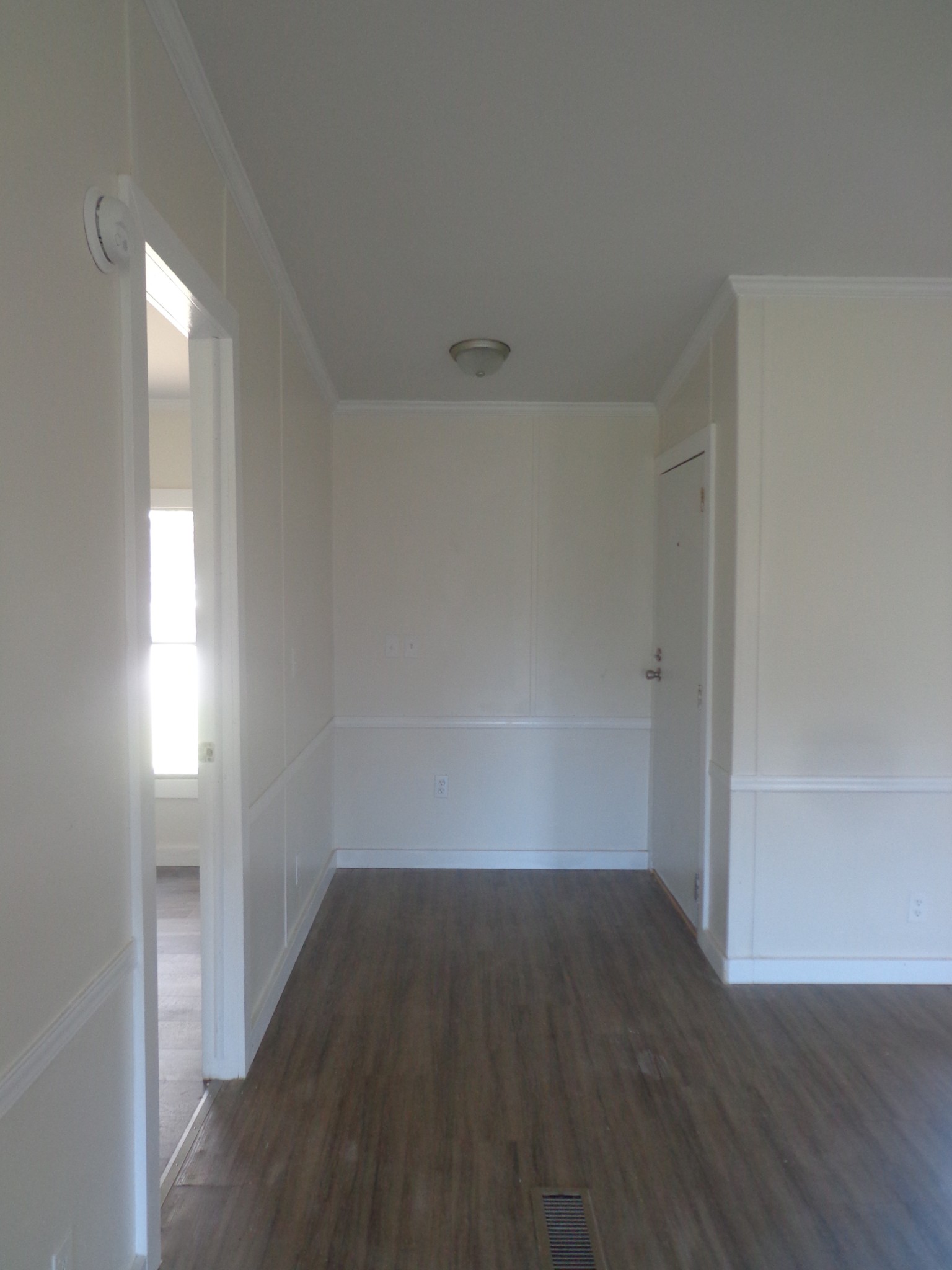 152 Baker Ridge Road Waverly, TN 37185 - Photo 3 of 20 an empty room with wooden floor and windows
