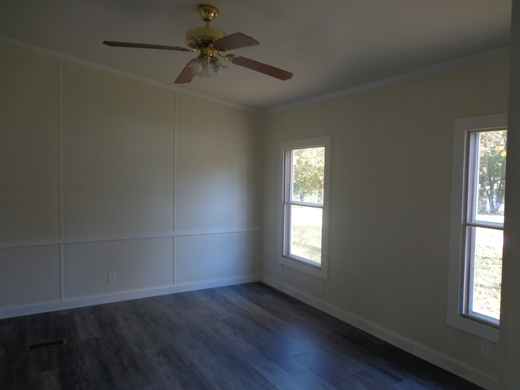152 Baker Ridge Road Waverly, TN 37185 - Photo 6 of 20 an empty room with wooden floor fan and windows