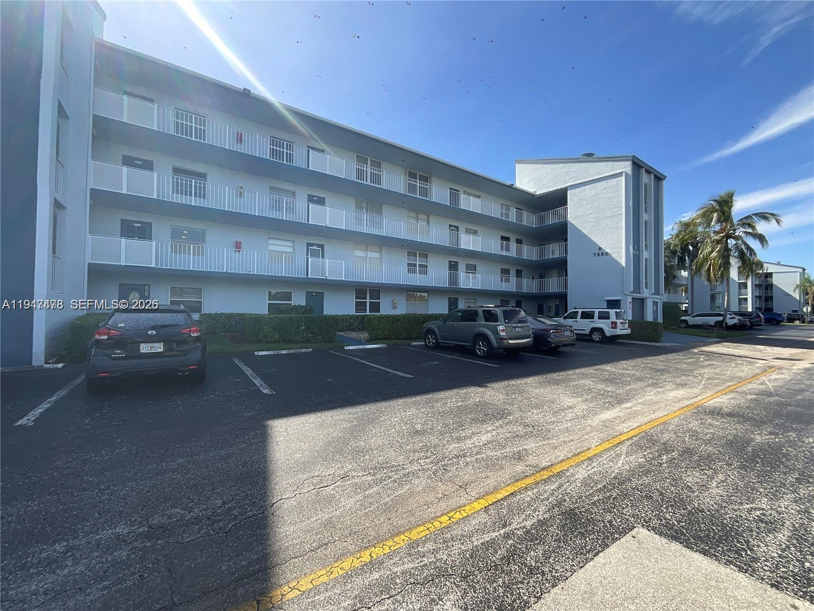 7690 Northwest 18th Street, Unit 306 Margate, FL 33063 - Photo 1 of 30 a view of building with cars parked