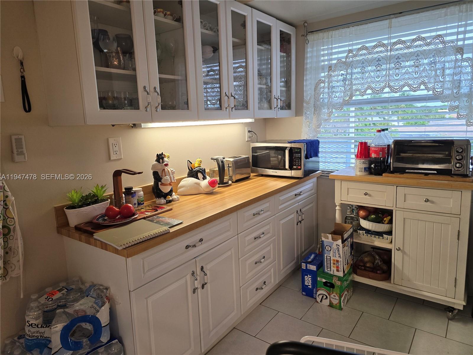 7690 Northwest 18th Street, Unit 306 Margate, FL 33063 - Photo 11 of 30 a kitchen with a sink cabinets and window