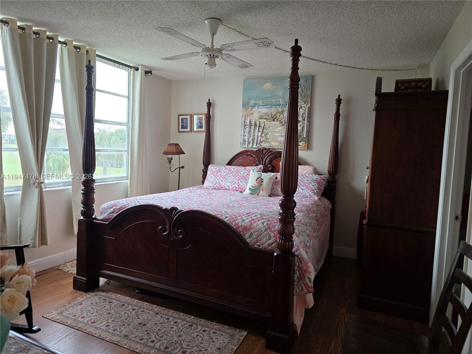 7690 Northwest 18th Street, Unit 306 Margate, FL 33063 - Photo 13 of 30 a bedroom with a bed dresser and a window