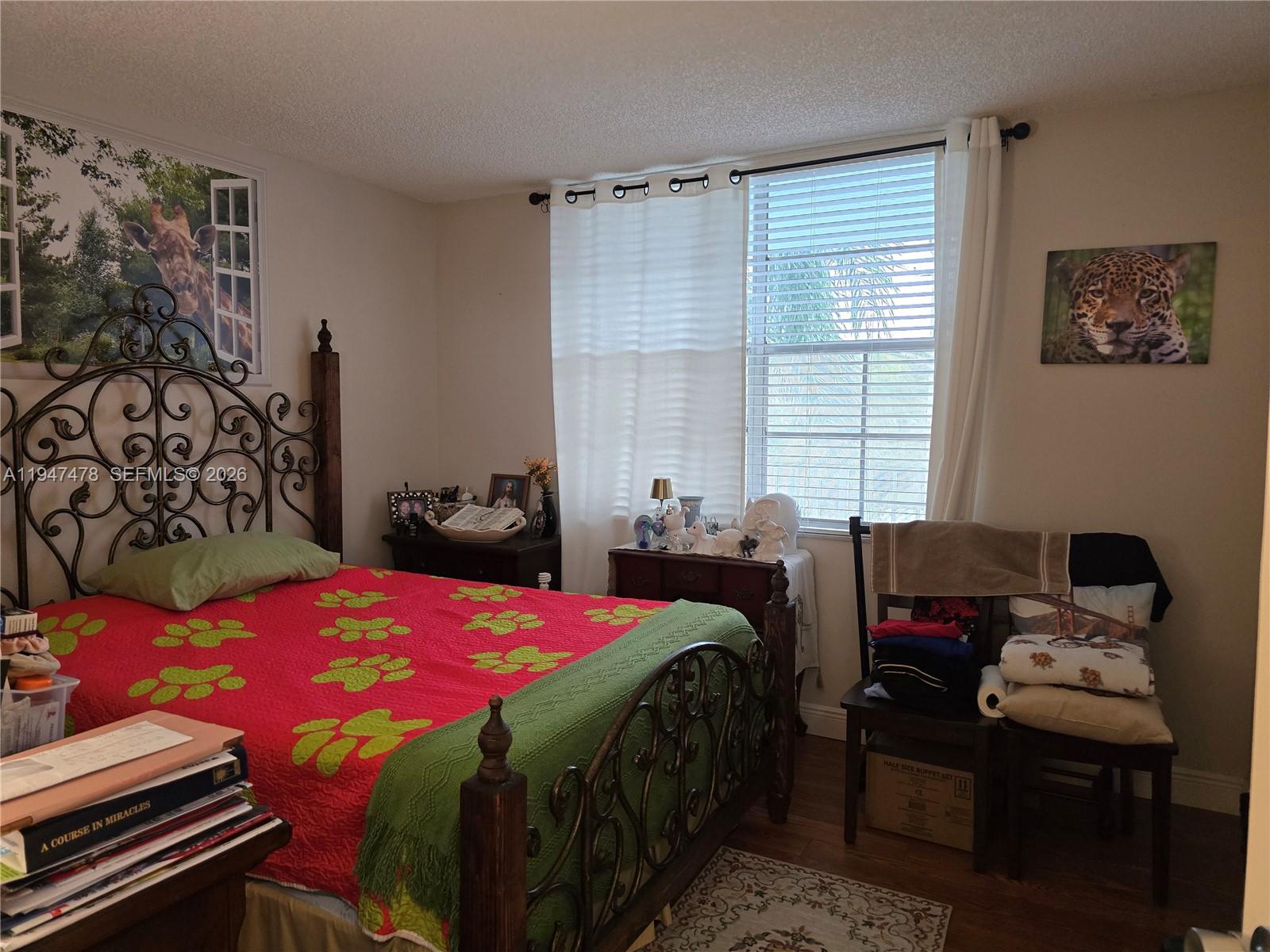 7690 Northwest 18th Street, Unit 306 Margate, FL 33063 - Photo 15 of 30 a bedroom that has a bed and a window