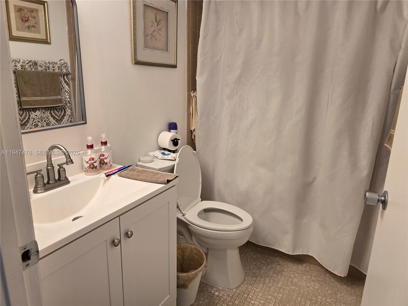 7690 Northwest 18th Street, Unit 306 Margate, FL 33063 - Photo 16 of 30 a bathroom with a sink and a toilet