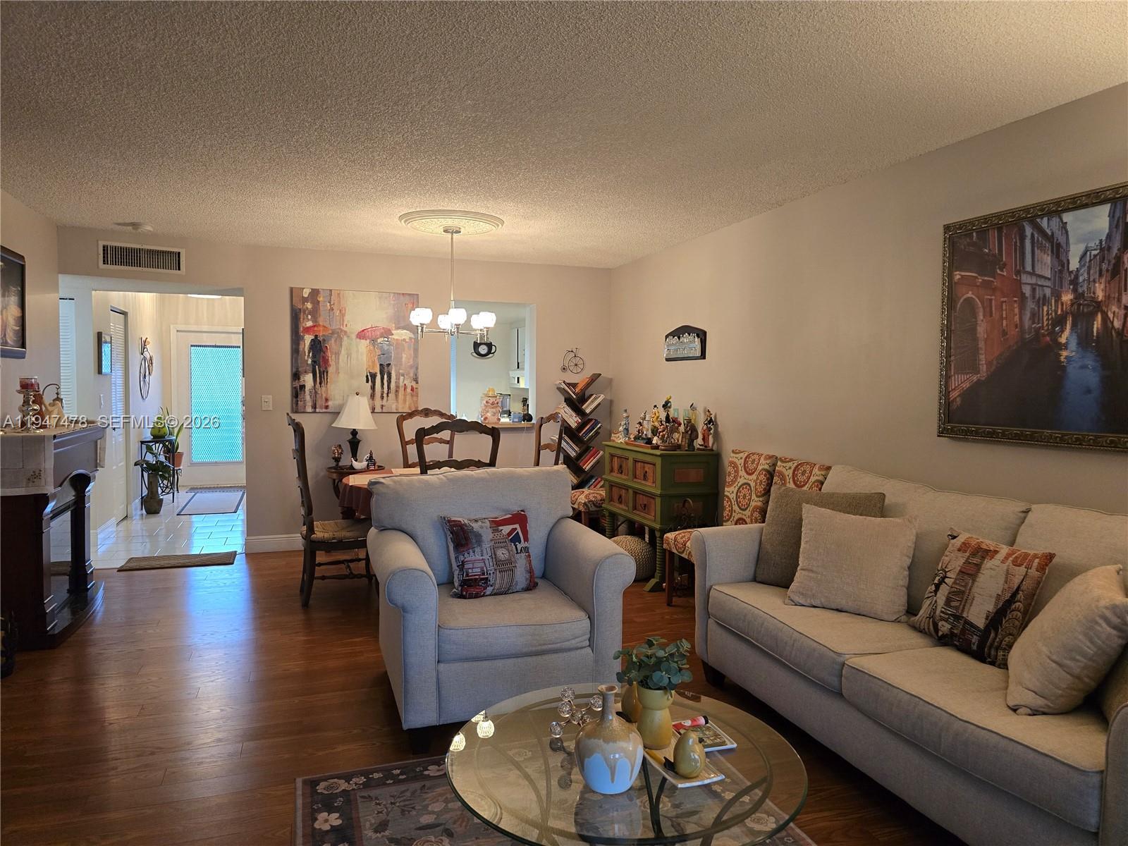 7690 Northwest 18th Street, Unit 306 Margate, FL 33063 - Photo 2 of 30 a living room with furniture and wooden floor
