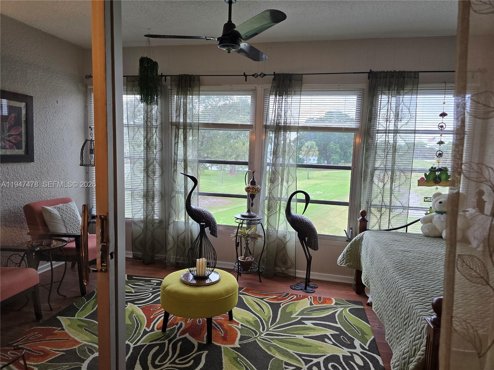 7690 Northwest 18th Street, Unit 306 Margate, FL 33063 - Photo 7 of 30 a living room with furniture and a large window