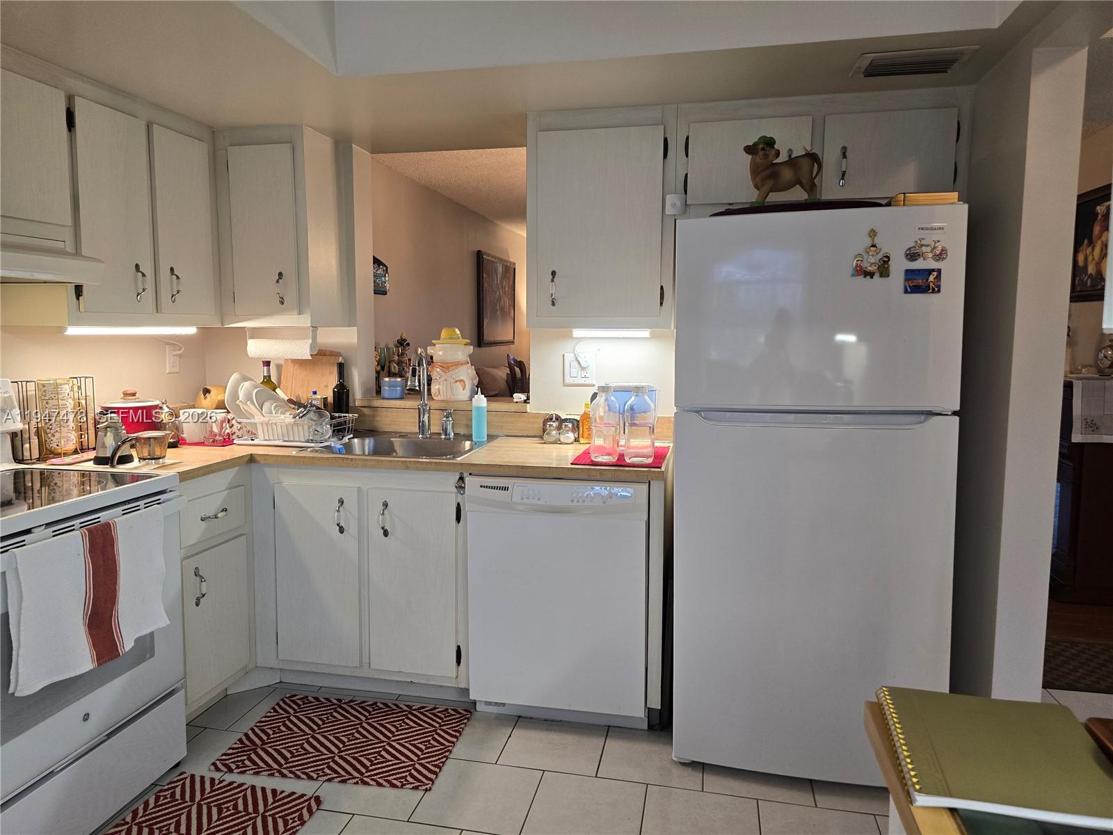 7690 Northwest 18th Street, Unit 306 Margate, FL 33063 - Photo 9 of 30 a kitchen with a refrigerator and cabinets