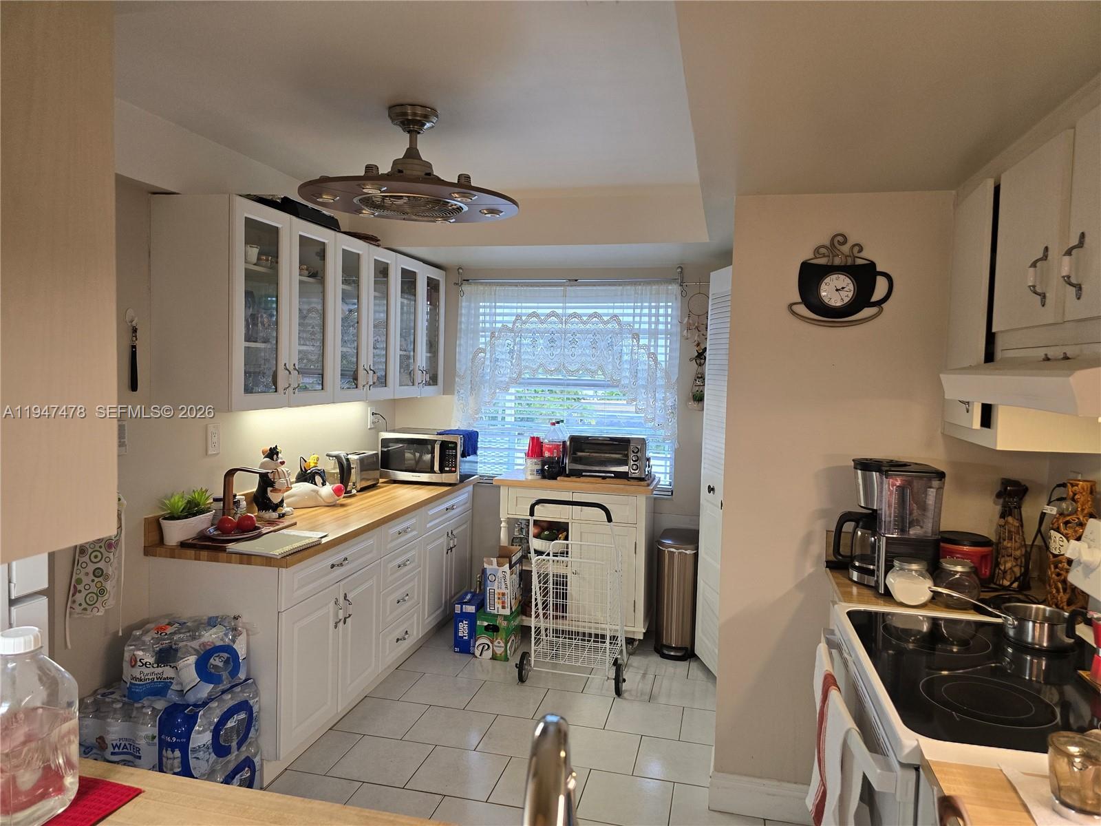 7690 Northwest 18th Street, Unit 306 Margate, FL 33063 - Photo 10 of 30 a kitchen with stainless steel appliances a stove a sink and cabinets